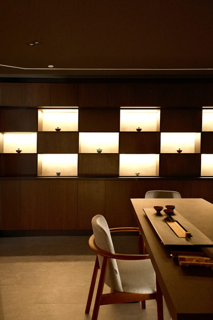 A private tea room showcasing Chinese tea culture with delicate teacups, offering a warm, earthy, and relaxing tea appreciation experience.