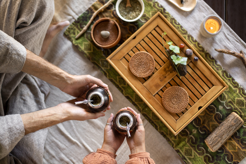 Pu erh tea : A traditional Chinese tea set featuring a clay teapot and small cups filled with warm, amber-coloured pu erh tea, set on a wooden tea tray.