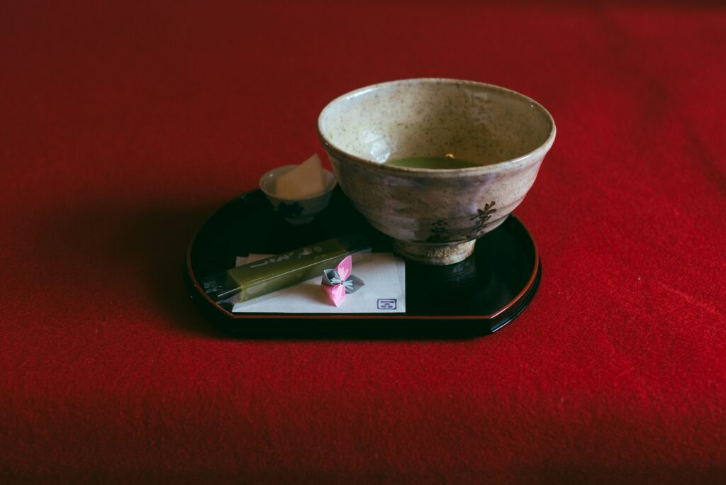 A beautifully whisked cup of vibrant green matcha tea, served in an artisanal bowl, showcasing its smooth froth and the serene artistry behind Japanese tea preparation.