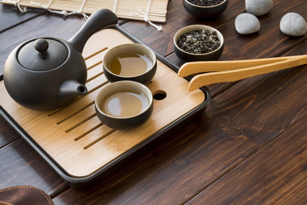 Cups filled with freshly brewed tea on a table, steam rising gently in a calm and minimalist scene.