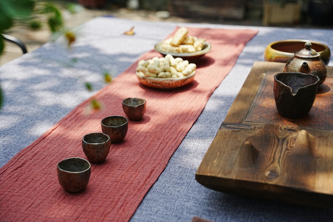 A beautifully arranged set of traditional Chinese teacups displayed on a wooden tea tray, prepared for a serene tea ceremony that highlights craftsmanship and cultural elegance