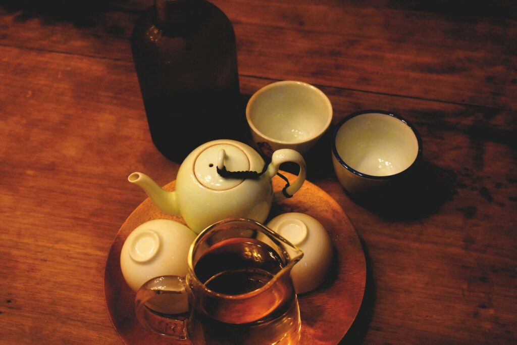 A refined Chinese tea-drinking ceremony in progress, showcasing delicate teaware, slow pouring techniques, and the graceful rituals that honour centuries-old tea traditions