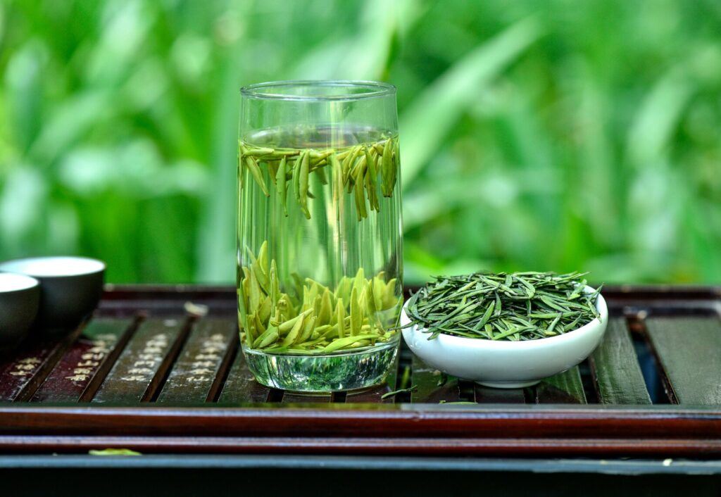 Green Tea : Premium Chinese green tea leaves displayed beside a teacup, symbolising quality and refinement.