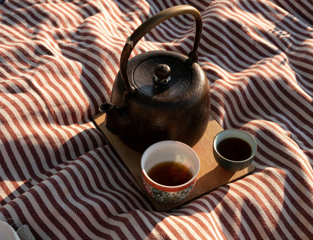A finely crafted Chinese tea cup sits on a wooden tray, its smooth glaze and balanced form highlighting the beauty of minimalist teaware design.