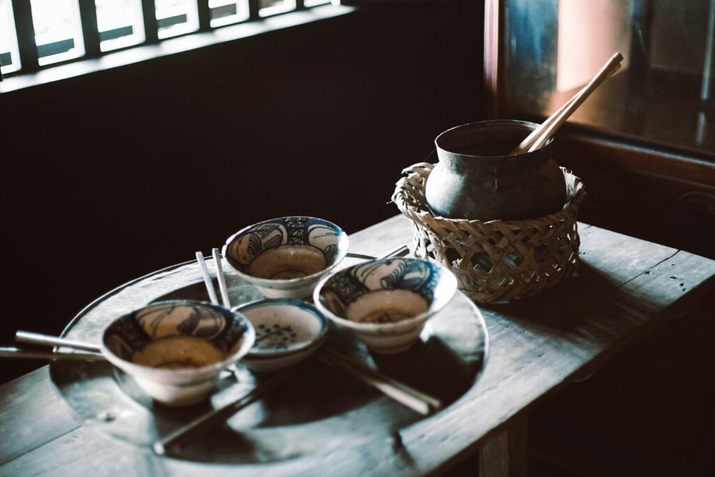 A neatly arranged set of elegant Chinese teacups on a wooden table, emphasising craftsmanship and timeless tea culture