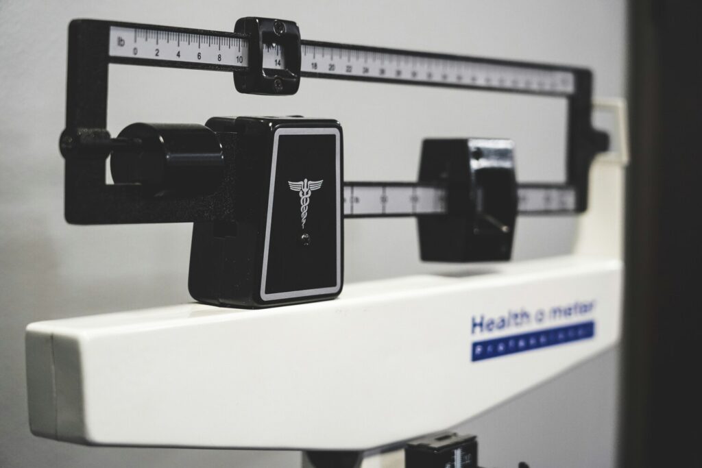 A weight scale placed on the floor, representing healthy weight management and mindful lifestyle choices for long-term wellness.