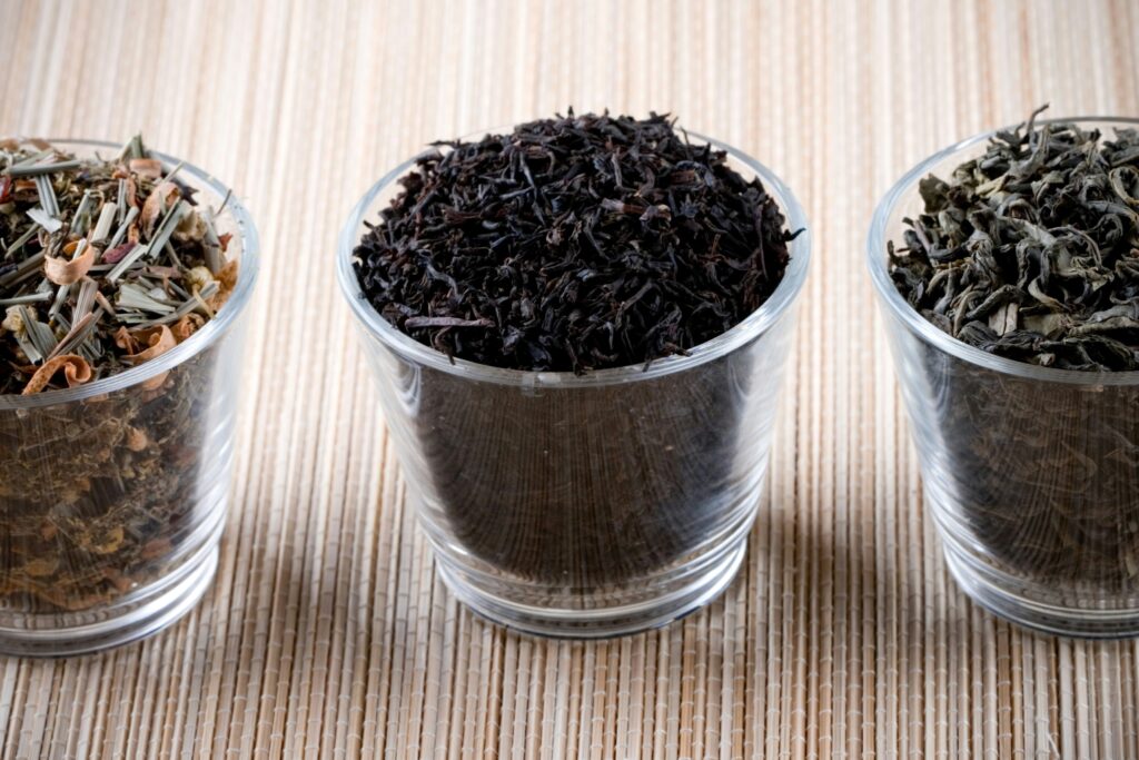 A curated display of tea leaves ranging from robust black tea to delicate white tea, showcasing the diversity, craftsmanship, and refined character of fine tea varieties.