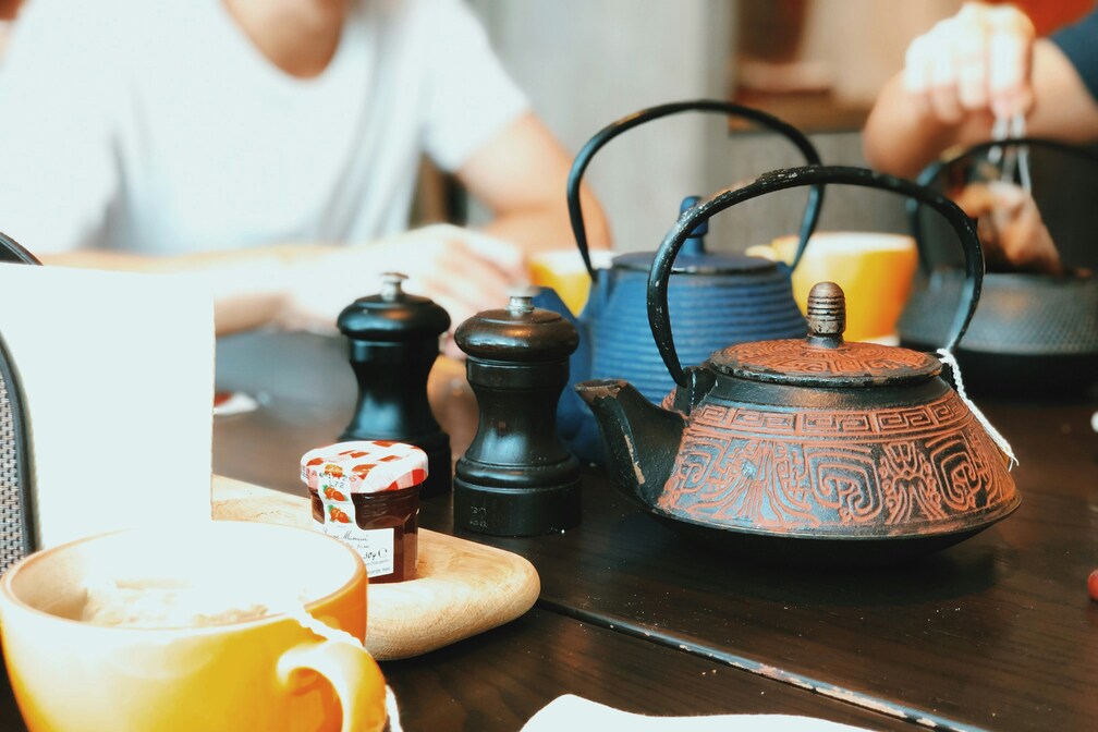A family enjoying Chinese tea together at a table, sharing moments of warmth, connection, and cultural appreciation