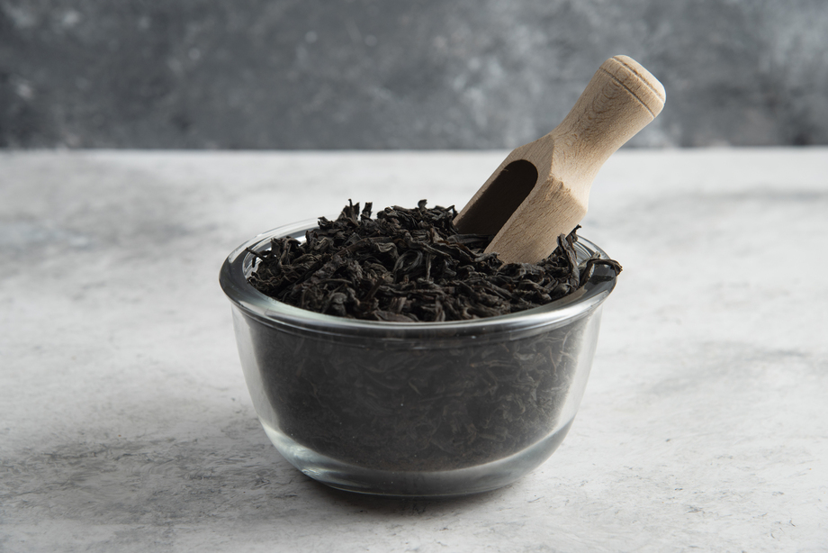 Close-up of loose black tea leaves, showcasing their rich texture and deep aroma, symbolising purity and quality.
