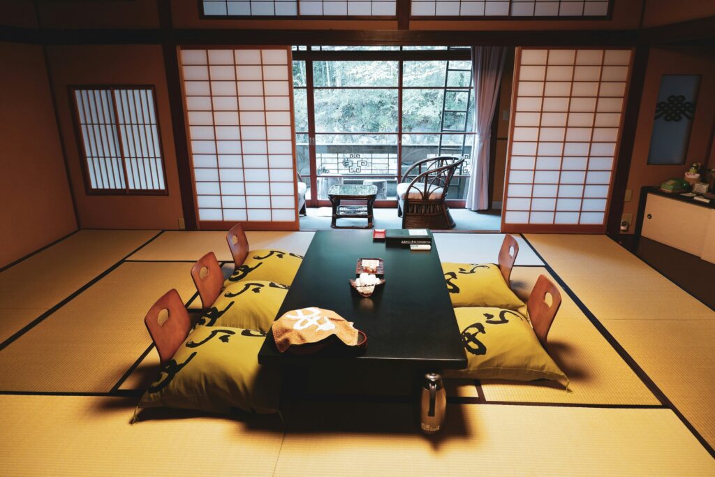 The image depicts a traditional Japanese tea room featuring tatami mats and minimalistic decorations, embodying the serene atmosphere essential for the Japanese tea ceremony. This setting highlights the cultural significance of tea drinking, where brewed tea, often made from high-quality tea leaves, is enjoyed in a tranquil environment.