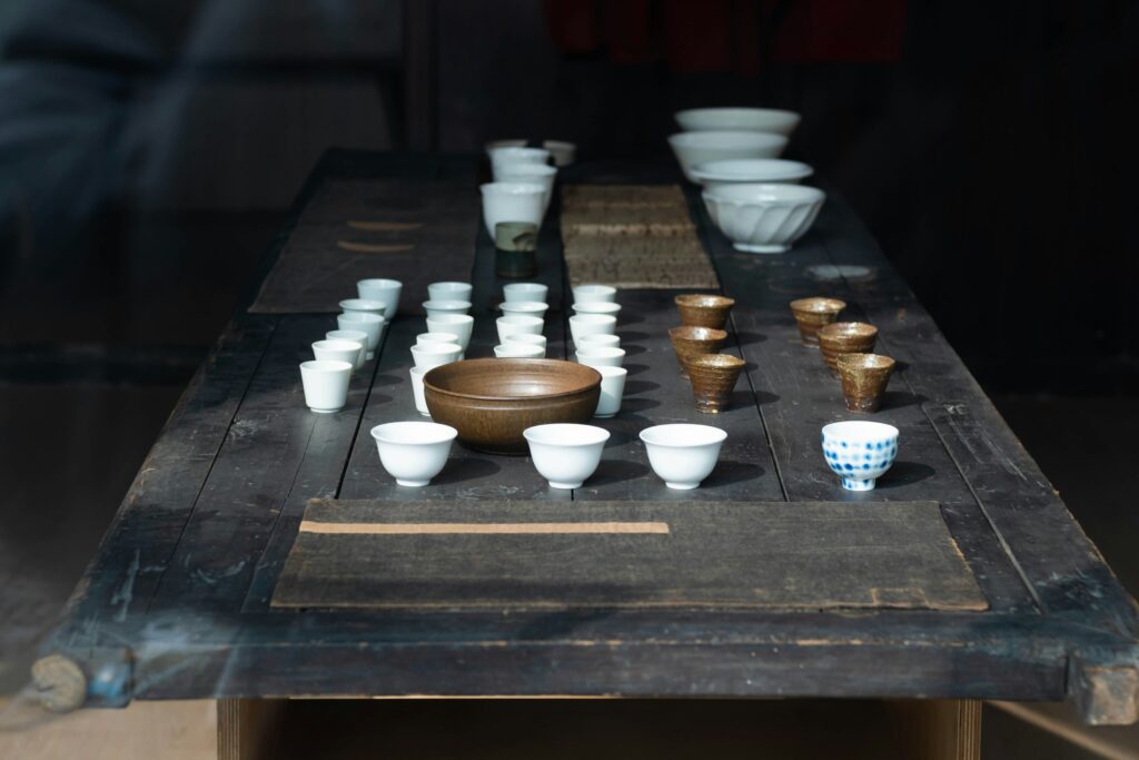 A selection of distinct tea sets laid out on the table, each chosen to complement different types of tea and enhance their individual aromas and flavours.
