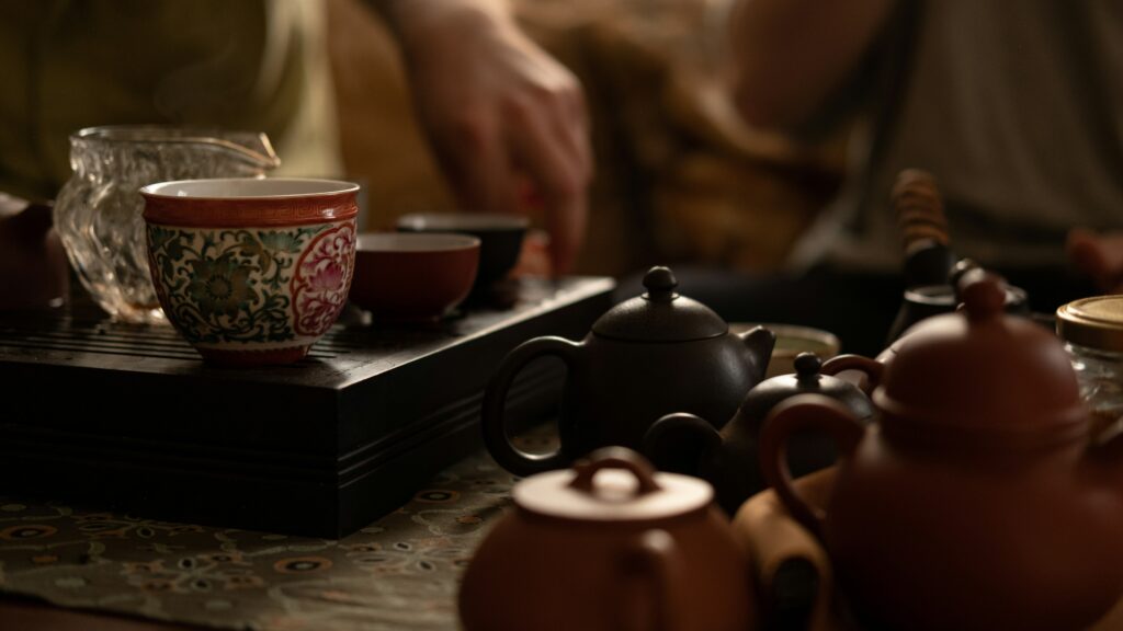 A classic Yixing clay teapot resting on the tea table, prized for its porous texture that absorbs tea essence and deepens flavour with every brew over time.