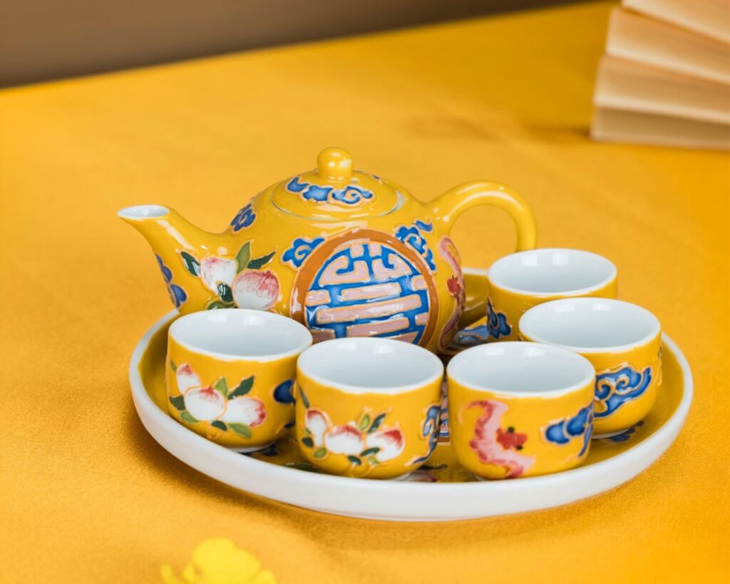 A bright yellow tea cup set that represents royalty and harmony, often associated with imperial Chinese tea culture.