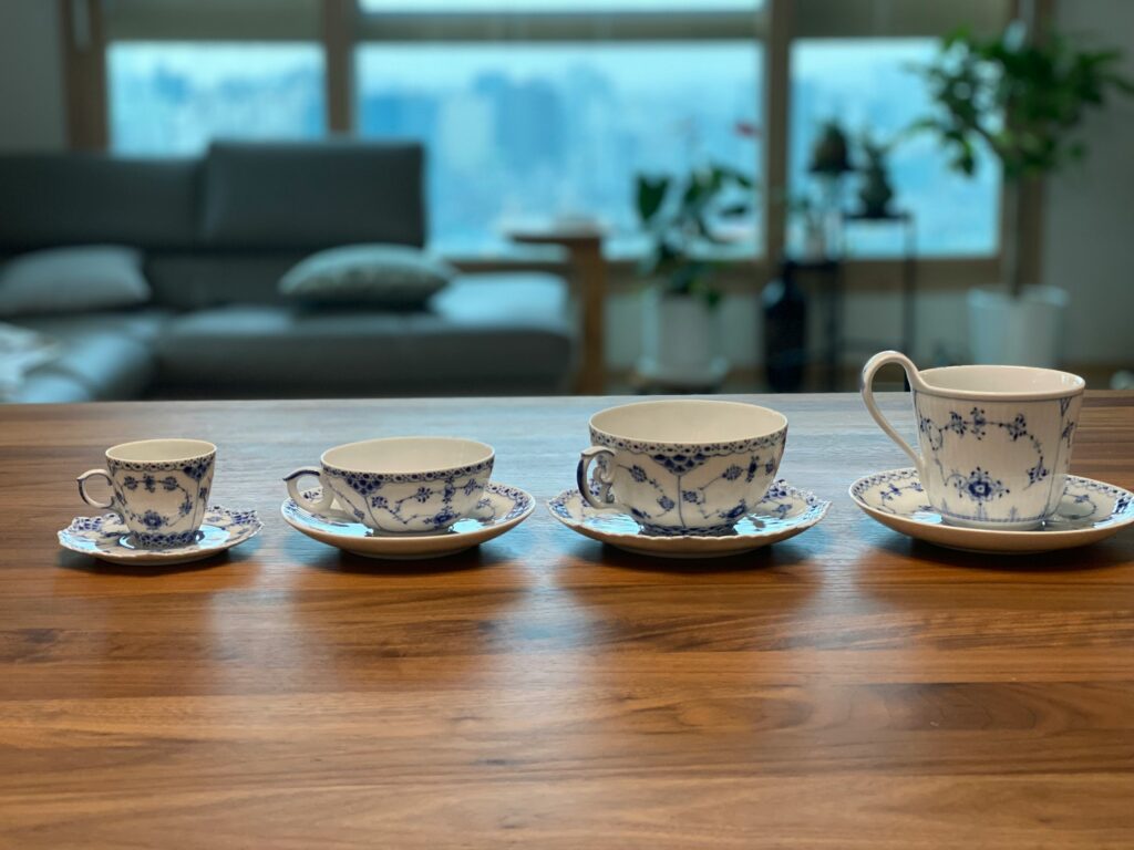 Lightweight bone china tea cups with a smooth ivory finish, known for their translucency and graceful form.