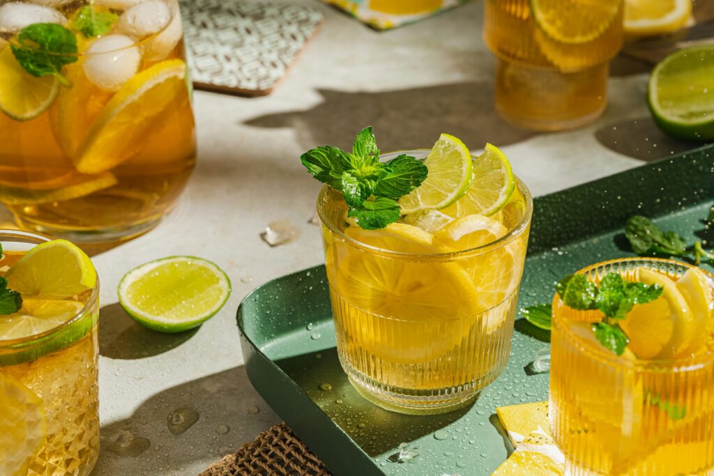 A modern tea presentation garnished with fresh lemon slices and mint leaves, reflecting contemporary tea culture that blends flavour, wellness, and visual appeal.