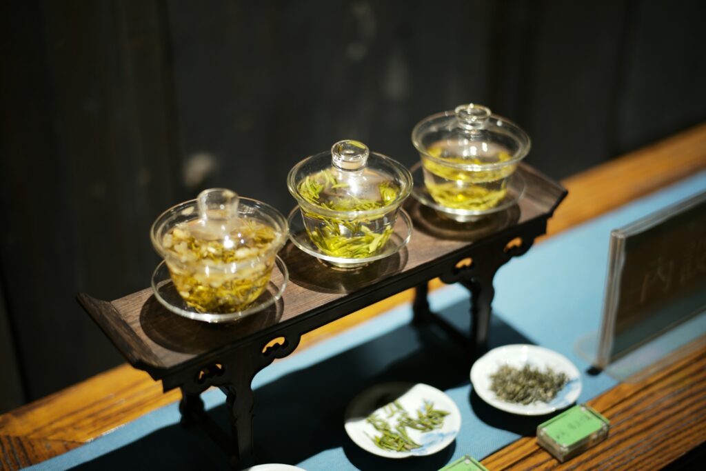 Three elegant teacups filled with green tea, representing shared moments and refined tea appreciation.