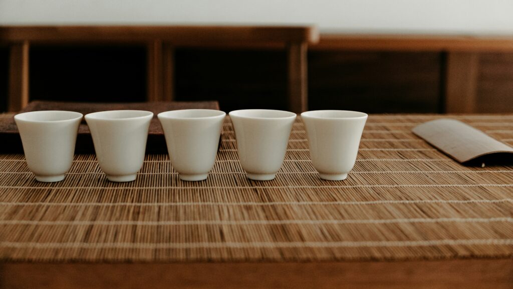 A slender Wenxiang Bei tea cup on the table, traditionally used to capture and savour the lingering fragrance of fine Chinese tea.