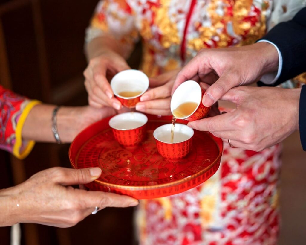 Offering tea in Chinese culture represents respect, gratitude, and the passing of blessings across generations.
