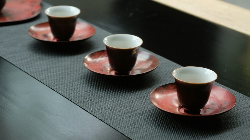 An iron-red Chinese tea cup with a rich, earthy glaze, reflecting depth, strength, and the heritage of traditional kiln techniques.