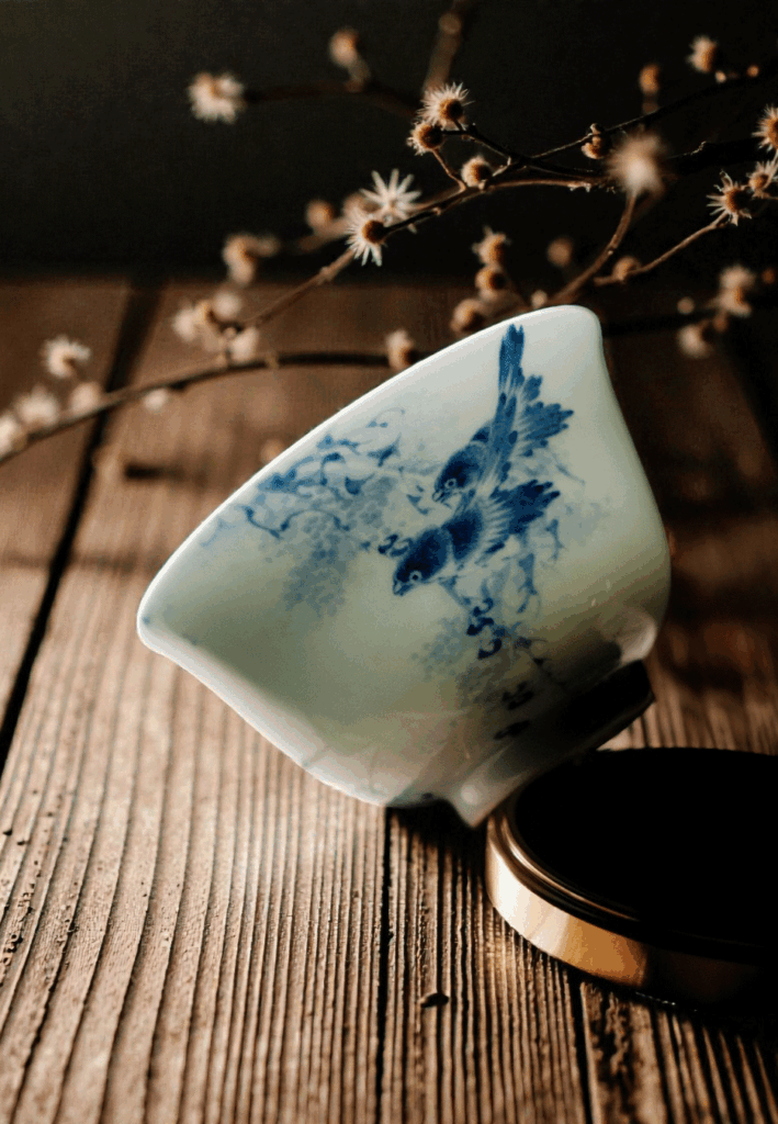 A single Chinese teacup stands on the table under soft natural sunlight, creating a serene atmosphere for tea enjoyment.