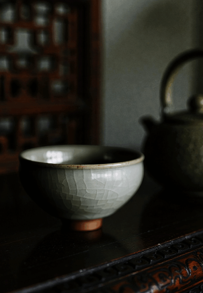 A close view of teacups displayed on a table, highlighting their textures and inviting guests to enjoy a peaceful tea moment.