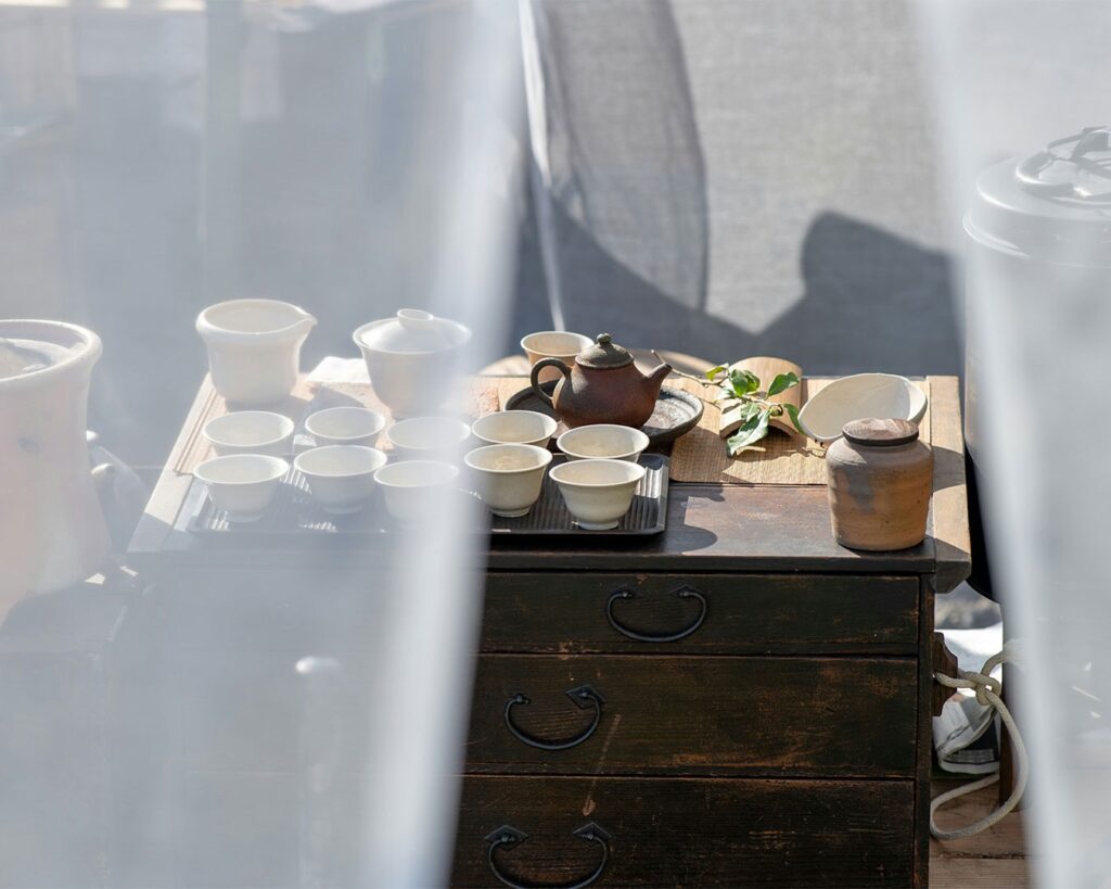 A collection of traditional teapots displayed neatly on a wooden table, reflecting the variety of vessels used in Chinese tea culture.