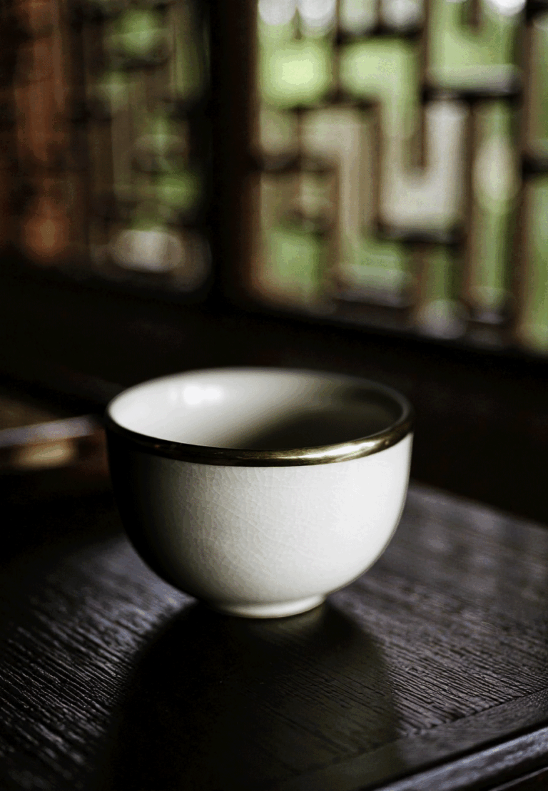 A single, spotless teacup showcased against a simple background, emphasising its smooth shape and refined finish.