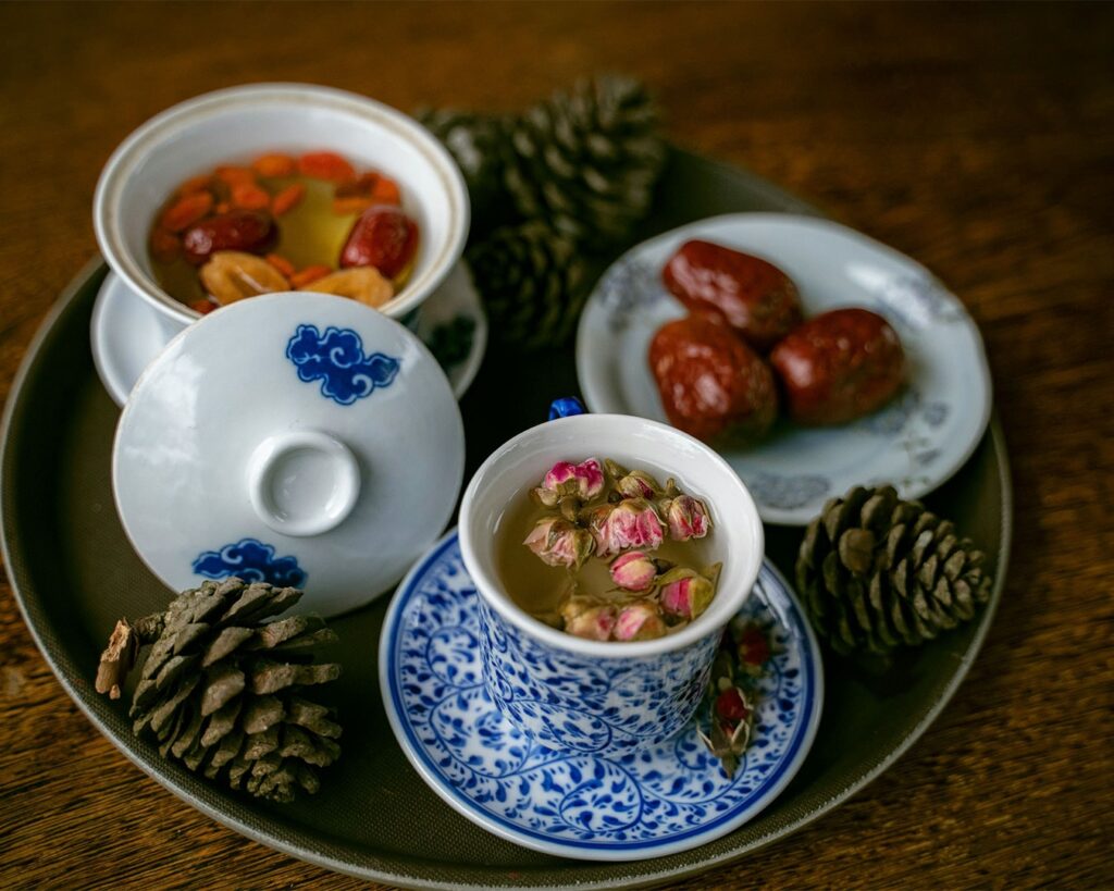 A traditional Chinese herbal tea served in a simple cup, highlighting its deep colour and comforting warmth.