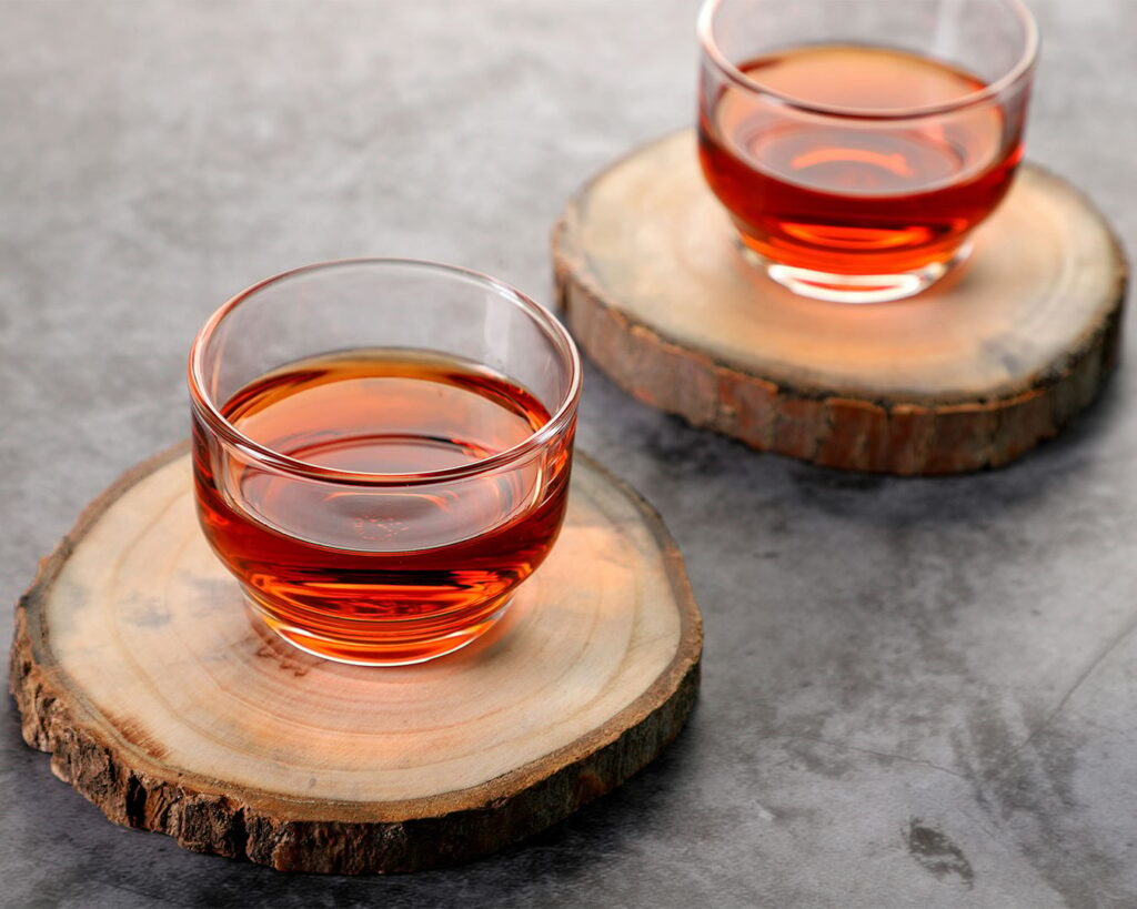 A warm cup of tea served in a ceramic teacup, with gentle steam rising, creating a calm and comforting atmosphere associated with relaxation and daily rituals.