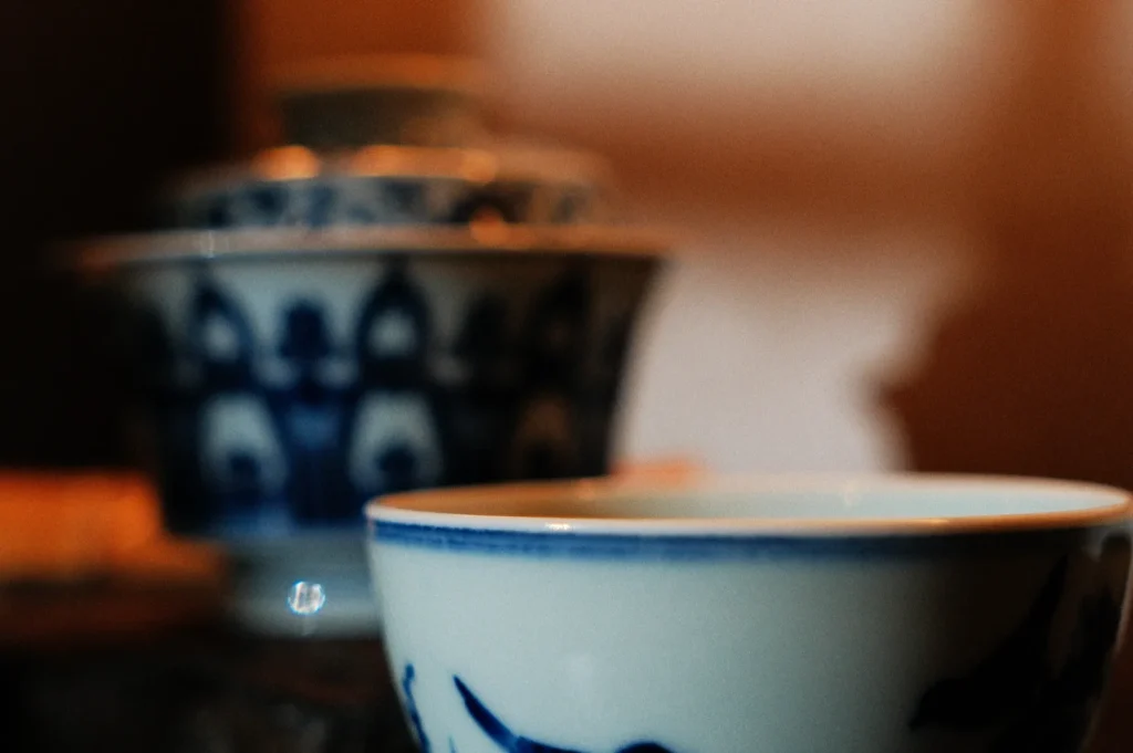 Close-up of two traditional blue and white porcelain bowls, with intricate patterns. The foreground bowl is sharp, while the background is softly blurred.