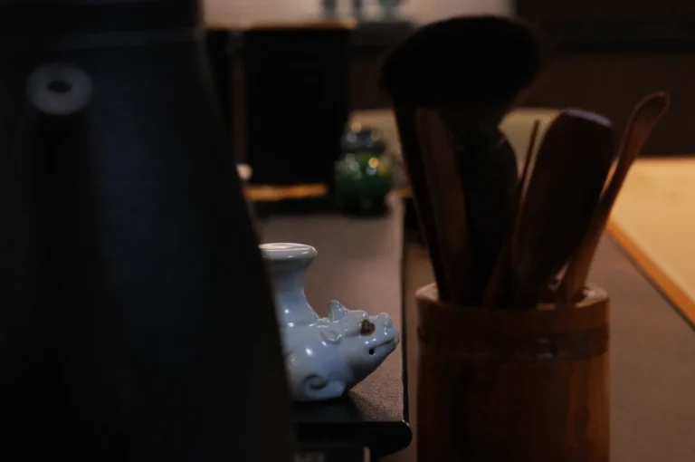 A close-up of kitchen utensils and containers on a counter, with a blurred background.